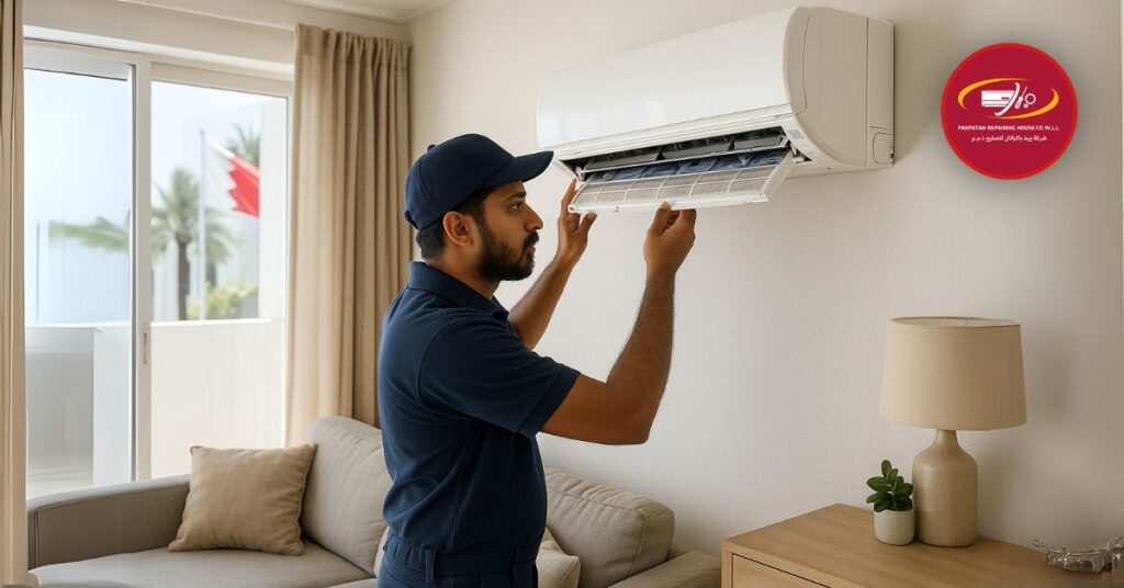 Technician in blue uniform repairing split AC inside Bahraini home.